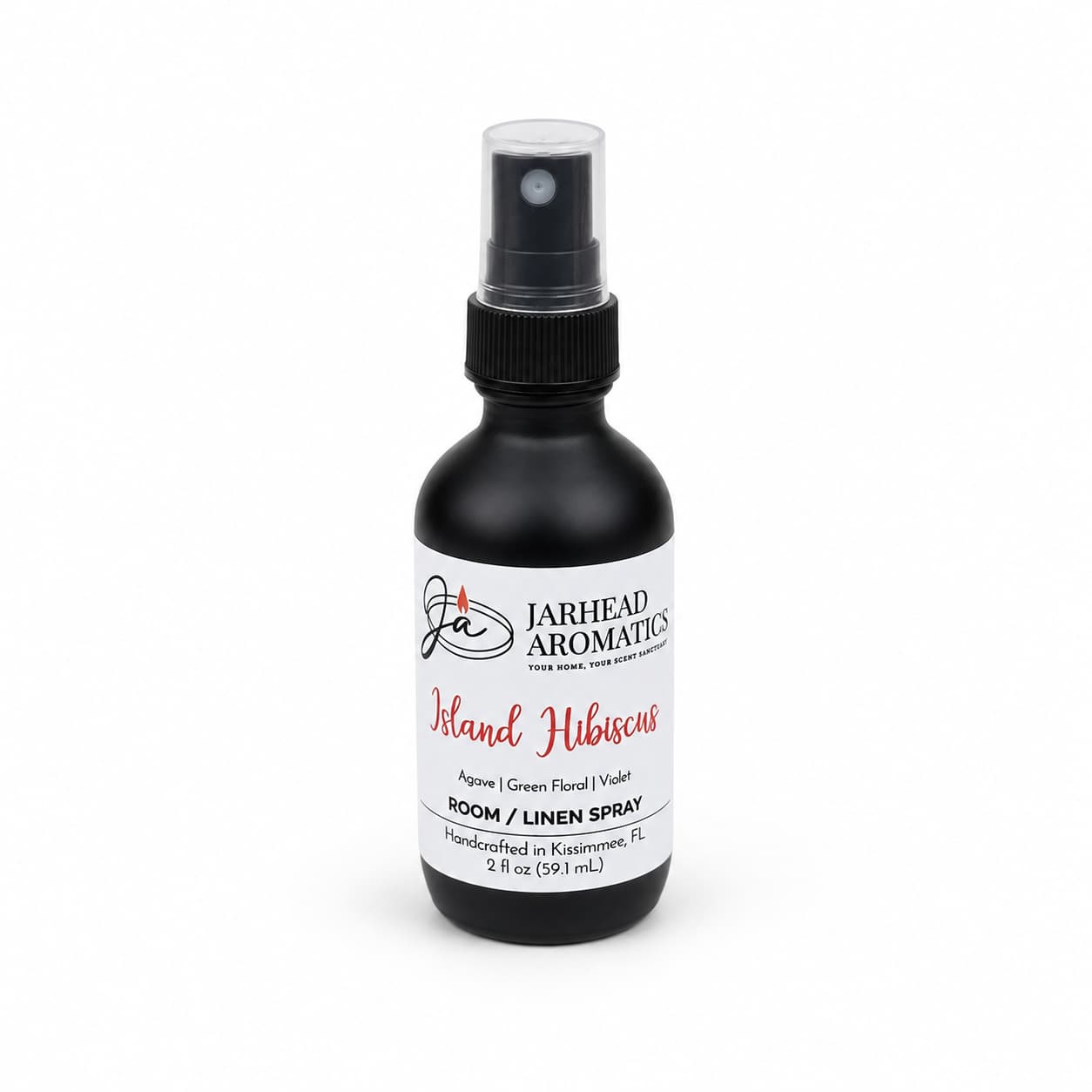 A black spray bottle labeled Jarhead Aromatics Island Hibiscus Room & Linen Spray in the Honeydew, Lime & Tropical Florals scent, featuring a refreshing tropical fragrance. This spray holds 2 fl oz and is handcrafted in Kissimmee, FL.