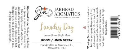 White label for Jarhead Aromatics Laundry Day Room & Linen Spray | Fresh Linen, Lemon & Clean Musk, featuring black and gold text with a flame logo at the top left. Includes directions, warning, ingredients (Fresh Linen, Lemon & Clean Musk), barcode, and handcrafted note. This clean home fragrance revitalizes any space with the fresh scent of linen enhanced by crisp lemon and clean musk notes.