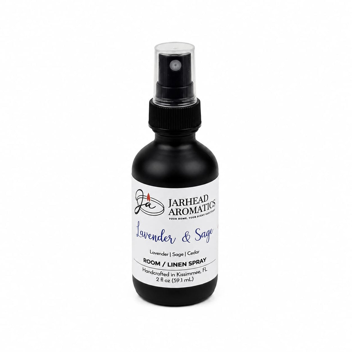 A black spray bottle labeled Jarhead Aromatics Lavender & Sage Room & Linen Spray (Lavender, Sage & Sandalwood) is displayed against a white background, providing a calming fragrance ideal for use as both a room and linen spray.