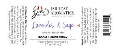 Label Description: The product label for Jarhead Aromatics Lavender & Sage Room & Linen Spray | Lavender, Sage & Sandalwood features directions, ingredients, warnings, and location details. Adorned with a candle logo and purple text, the label highlights this calming home fragrance designed to refresh any space or linen with the soothing blend of lavender, sage, and sandalwood.
