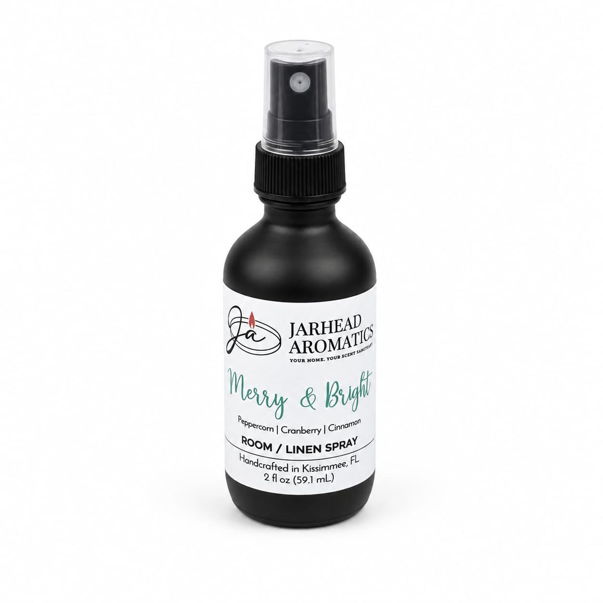A black spray bottle with a white label for Merry & Bright Room & Linen Spray, featuring notes of citrus cranberry, warm spice, and fir.