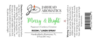 Product label for a Merry & Bright Room & Linen Spray by Jarhead Aromatics, featuring notes of citrus, cranberry, spice, and fir, with usage directions, safety warnings, and a barcode.