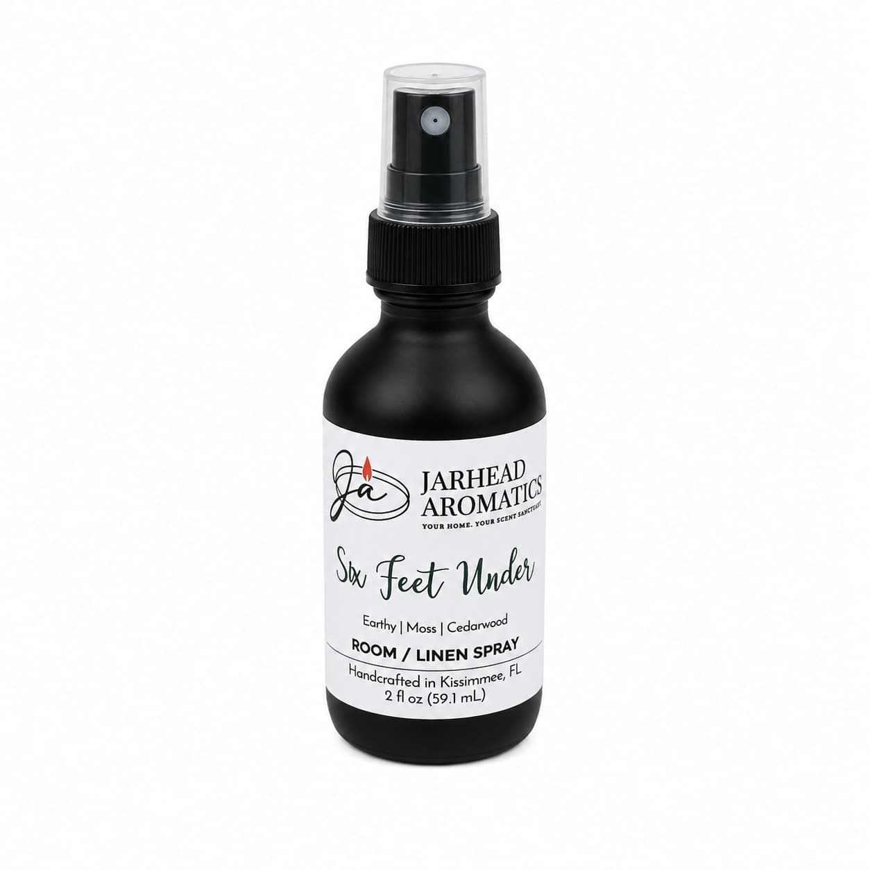 A 2 oz black spray bottle of Jarhead Aromatics Six Feet Under Room & Linen Spray, handcrafted in Kissimmee, FL and featuring captivating scents of damp earth, moss, and ancient oak for an inviting home fragrance.