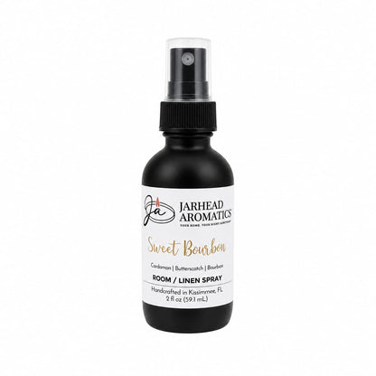 A black spray bottle of Jarhead Aromatics Sweet Bourbon Room & Linen Spray (2 fl oz), featuring a rich blend of bourbon, butterscotch, and brown sugar notes. Handcrafted in Kissimmee, FL, this luxurious gourmand fragrance enhances any space and is elegantly displayed on a white background.
