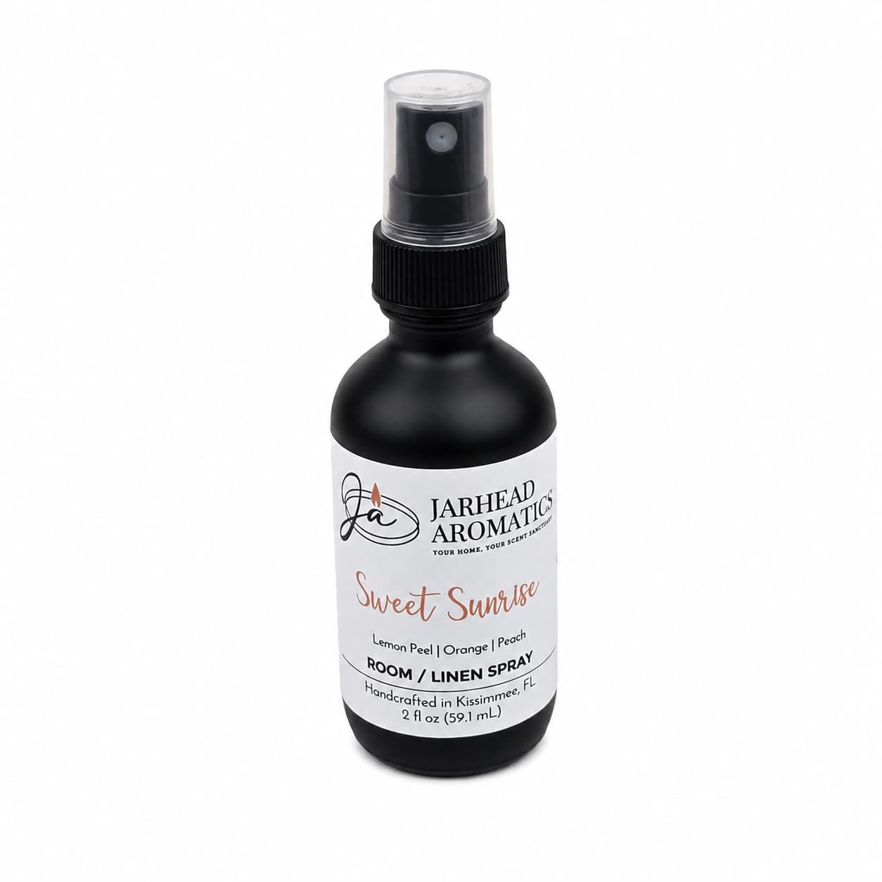 A black spray bottle of Jarhead Aromatics Sweet Sunrise Room & Linen Spray, featuring lemon, orange, peach, and citrus scents, offers a refreshing fruity fragrance for your home. This 2 fl oz spray comes with a clear cap for convenient use.