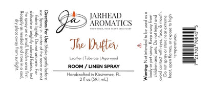 White label for Jarhead Aromatics The Drifter Room & Linen Spray | Leather, Tuberose & Smoky Agarwood. This western-inspired fragrance blends leather, tuberose, and smoky agarwood for a distinctive leather home scent. Includes usage directions, safety warning, product size (2 fl oz), and origin (Kissimmee, FL).