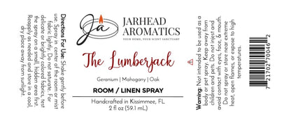 Jarhead Aromatics The Lumberjack Room & Linen Spray | Mahogany, Cedarwood & Oak label. Includes usage directions, safety warning, company logo featuring a candle, scent notes (Mahogany, Cedarwood, Oak), a handcrafted statement, location details, size (2 fl oz), and a barcode. This woodsy home fragrance captures the essence of fresh timberlands—perfect for anyone seeking a rugged yet refreshing atmosphere. Also ideal as a cedarwood-inspired spray.