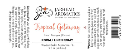A label for Jarhead Aromatics Tropical Getaway Room & Linen Spray in the Coconut, Mango & Pineapple scent, designed as a vibrant home fragrance. Includes instructions, warnings, and product details printed on a clean white background.