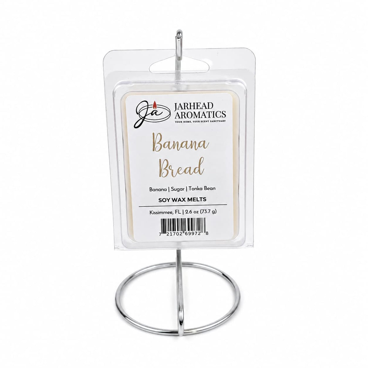 A package of Jarhead Aromatics Banana Bread Soy Wax Melt | Ripe Banana, Walnut & Warm Vanilla is displayed upright on a silver metal stand against a white background, showcasing its homemade-inspired fragrance with notes of ripe banana, walnut, and warm vanilla.