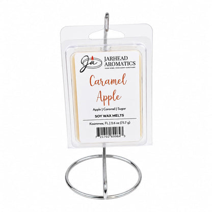 A package of Jarhead Aromatics Caramel Apple Soy Wax Melt | Crisp Apple, Rich Caramel & Warm Spice stands upright on a silver metal stand against a white background, showcasing this bakery-inspired wax melt that’s perfect for filling any space with cozy fall fragrance.