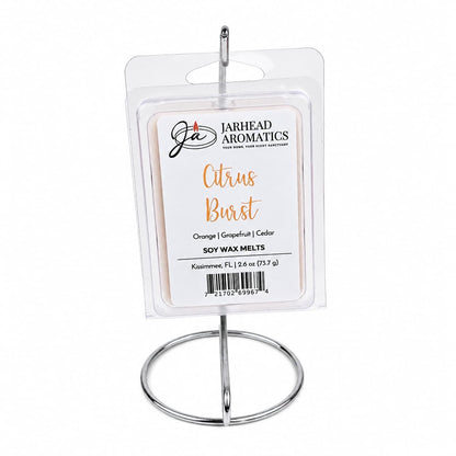 A package of Jarhead Aromatics Citrus Burst Soy Wax Melt | Orange, Mango, Peach & Grapefruit, ideal for enhancing your home fragrance experience, is showcased on a simple silver metal stand against a white background.