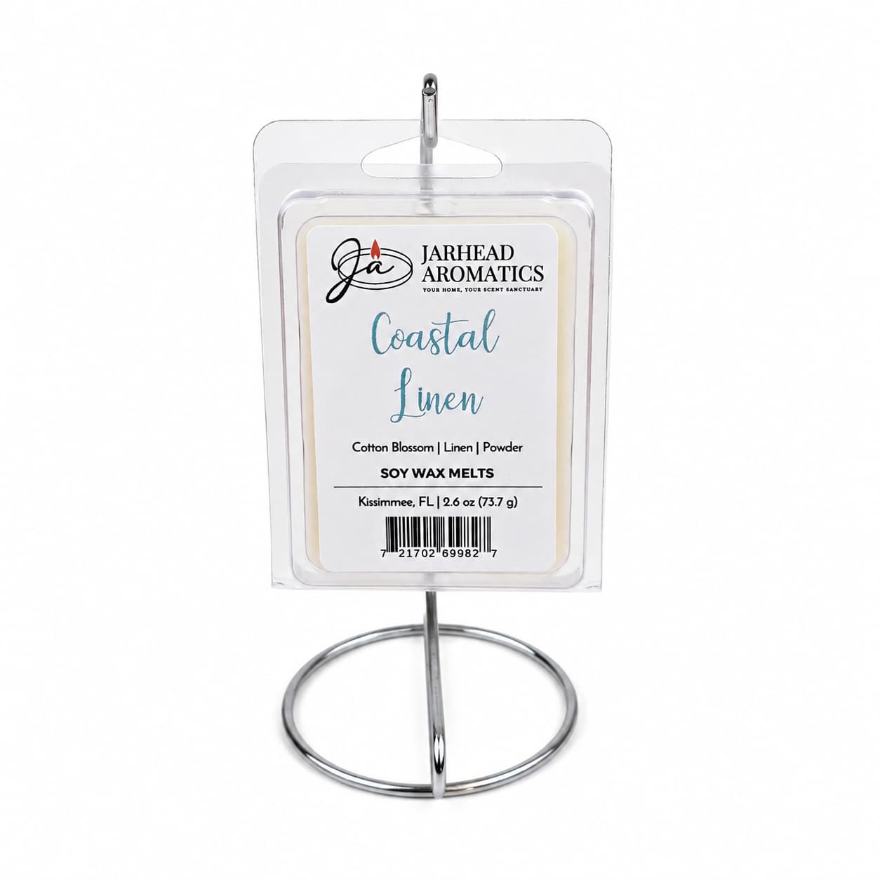 A package of Jarhead Aromatics Coastal Linen Soy Wax Melt | Fresh Linen, Ozone & Sandalwood is displayed upright on a silver metal stand against a plain white background, accentuating its blend of fresh linen, ozone, and sandalwood fragrances.