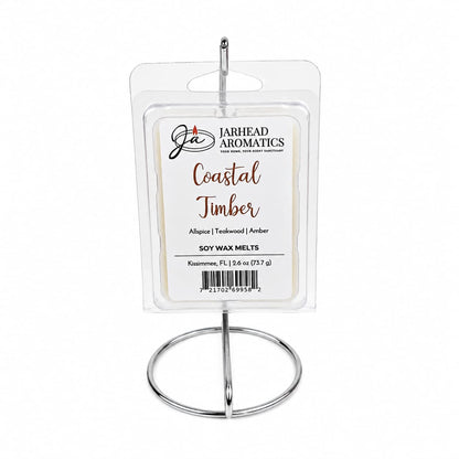 A package of Jarhead Aromatics Coastal Timber Soy Wax Melt | Teakwood, Leather & Warm Amber is displayed on a silver metal stand against a white background, perfect for enhancing your home fragrance.