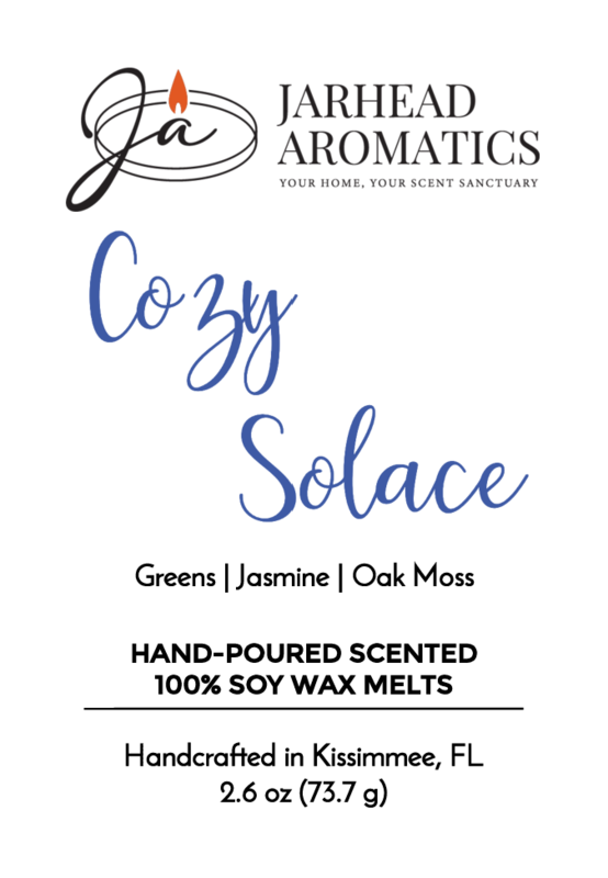 Product label for Jarhead Aromatics Cozy Solace - Soy Wax Melt (Fall Collection), scented with fresh greens, jasmine, and oak moss. Handcrafted in Kissimmee, FL. Includes logo, product info, and net wt. 2.6 oz.