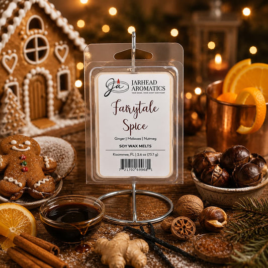 A package of Jarhead Aromatics Fairytale Spice Soy Wax Melt | Gingerbread, Molasses & Warm Spice is displayed among festive items like gingerbread cookies, oranges, nuts, a gingerbread house, cinnamon sticks, and a cup, evoking a cozy holiday atmosphere with its warm notes of gingerbread and spices.