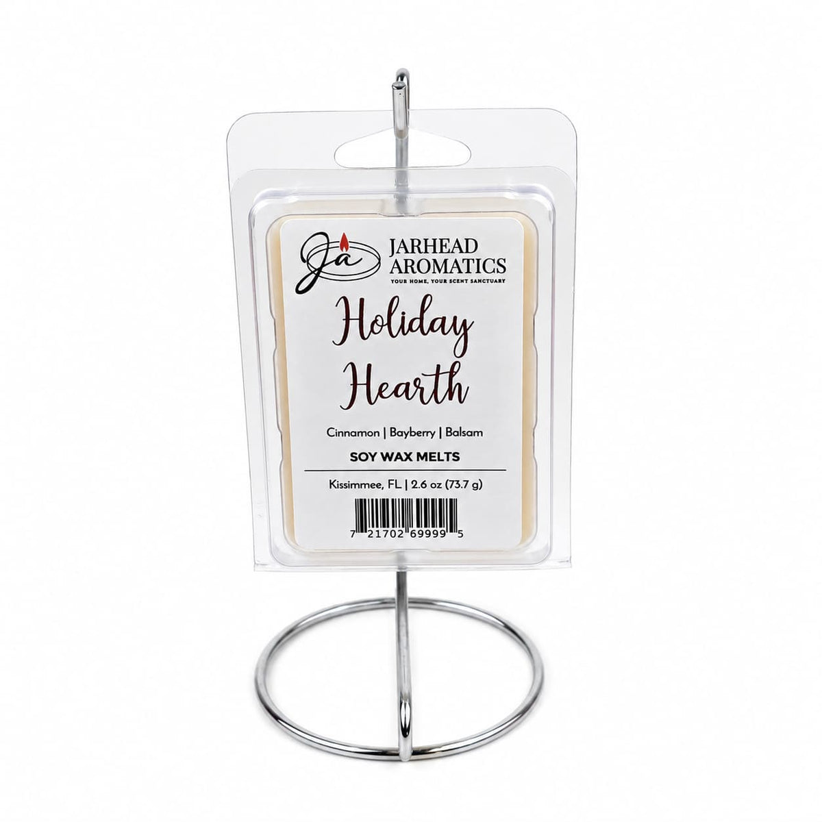 A package of Holiday Hearth Soy Wax Melt | Cinnamon Clove & Bayberry Holiday Scent by Jarhead Aromatics in a clear plastic clamshell, hanging from a circular wire display stand.