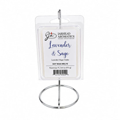 A package of Jarhead Aromatics Lavender & Sage Soy Wax Melt | Lavender, Sage & Sandalwood is displayed upright on a silver metal stand against a white background, highlighting this calming home fragrance and inviting the soothing aromas of lavender, sage, and sandalwood into your space.
