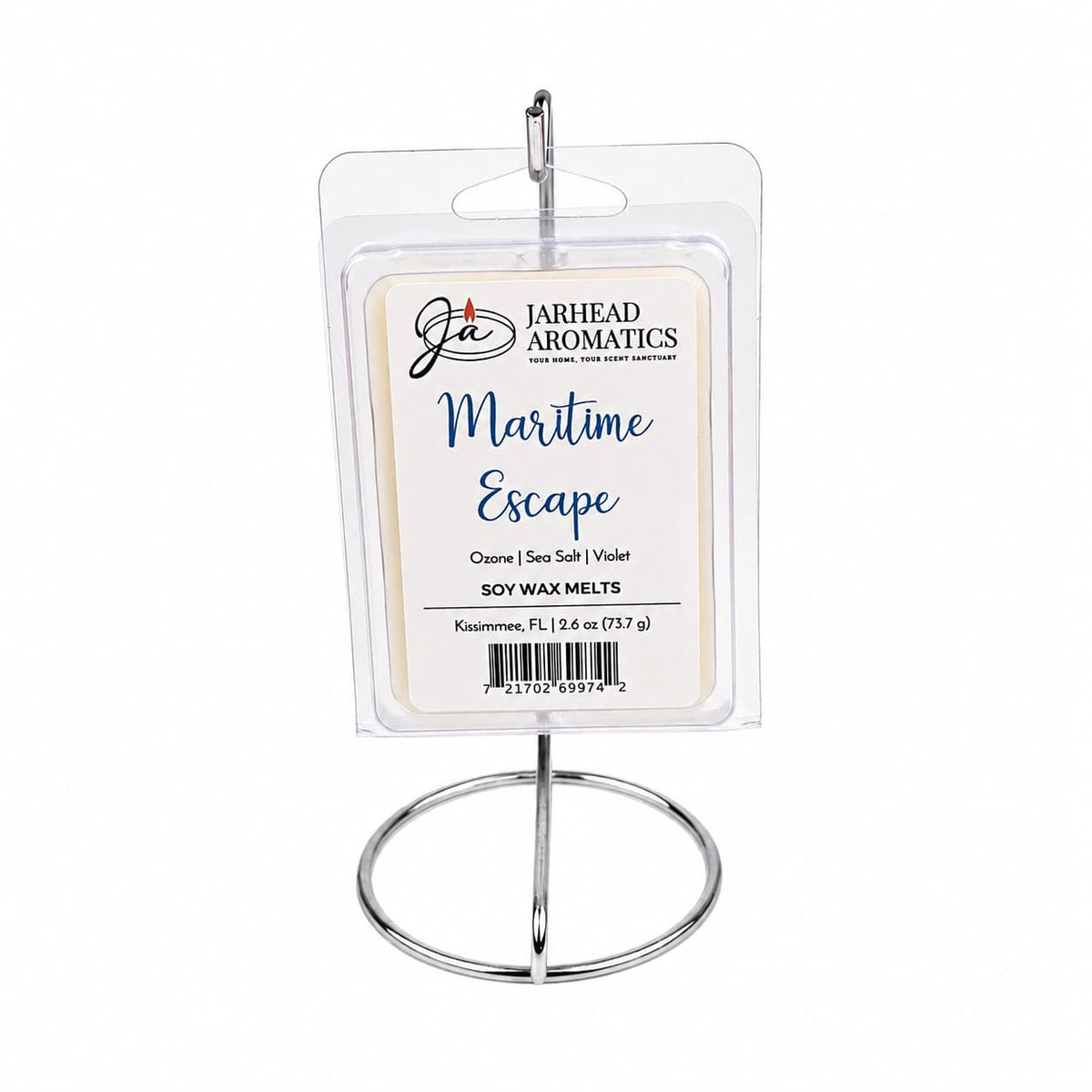A package of Jarhead Aromatics Maritime Escape Soy Wax Melt is displayed upright on a silver metal stand. The clear packaging prominently features the label, highlighting scent notes of sea salt, ozone, and jasmine for an invigorating ocean-inspired fragrance with subtle undertones of coastal freshness.