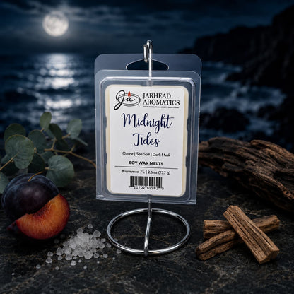 A package of Jarhead Aromatics Midnight Tides Soy Wax Melt—featuring sea salt, sandalwood, and dark musk—is displayed as a premium home fragrance on a dark table by the ocean under a moonlit sky.