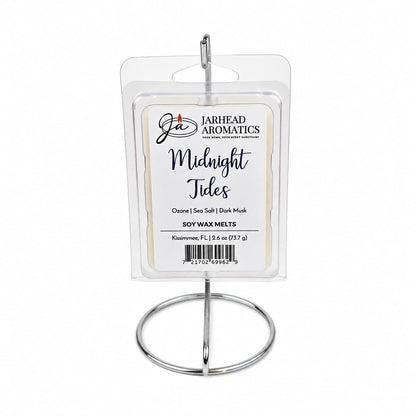 A Jarhead Aromatics Midnight Tides Soy Wax Melt pack, featuring sea salt, sandalwood, and dark musk fragrances, is displayed on a metal stand. The label highlights its aquatic and long-lasting scent.