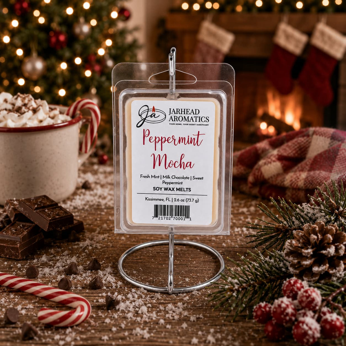 A Peppermint Mocha Soy Wax Melt in a clear plastic clamshell package, displayed on a metal stand on a wooden table with holiday decorations.