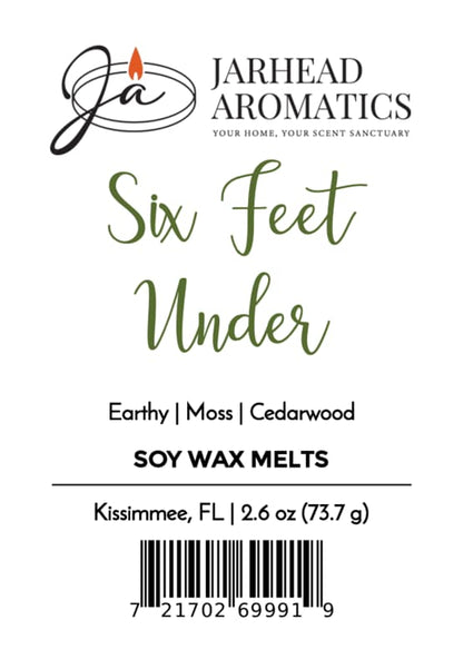Label for Jarhead Aromatics Six Feet Under Soy Wax Melt | Damp Earth, Moss & Ancient Oak, featuring a dark atmospheric fragrance with notes of earthy moss and ancient oak. Product info includes location (Kissimmee, FL), weight (2.6 oz), and a barcode at the bottom.