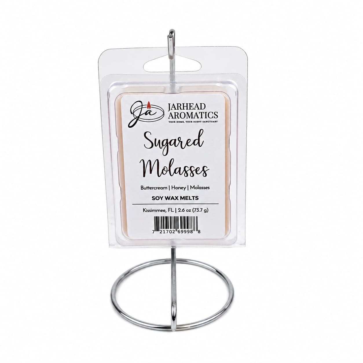 A package of Jarhead Aromatics Sugared Molasses Soy Wax Melt | Buttercream, Honey & Dark Molasses is displayed on a metal stand. These hand-poured soy wax melts feature comforting notes of buttercream, honey, and dark molasses to fill your space with a highly fragrant sweetness.