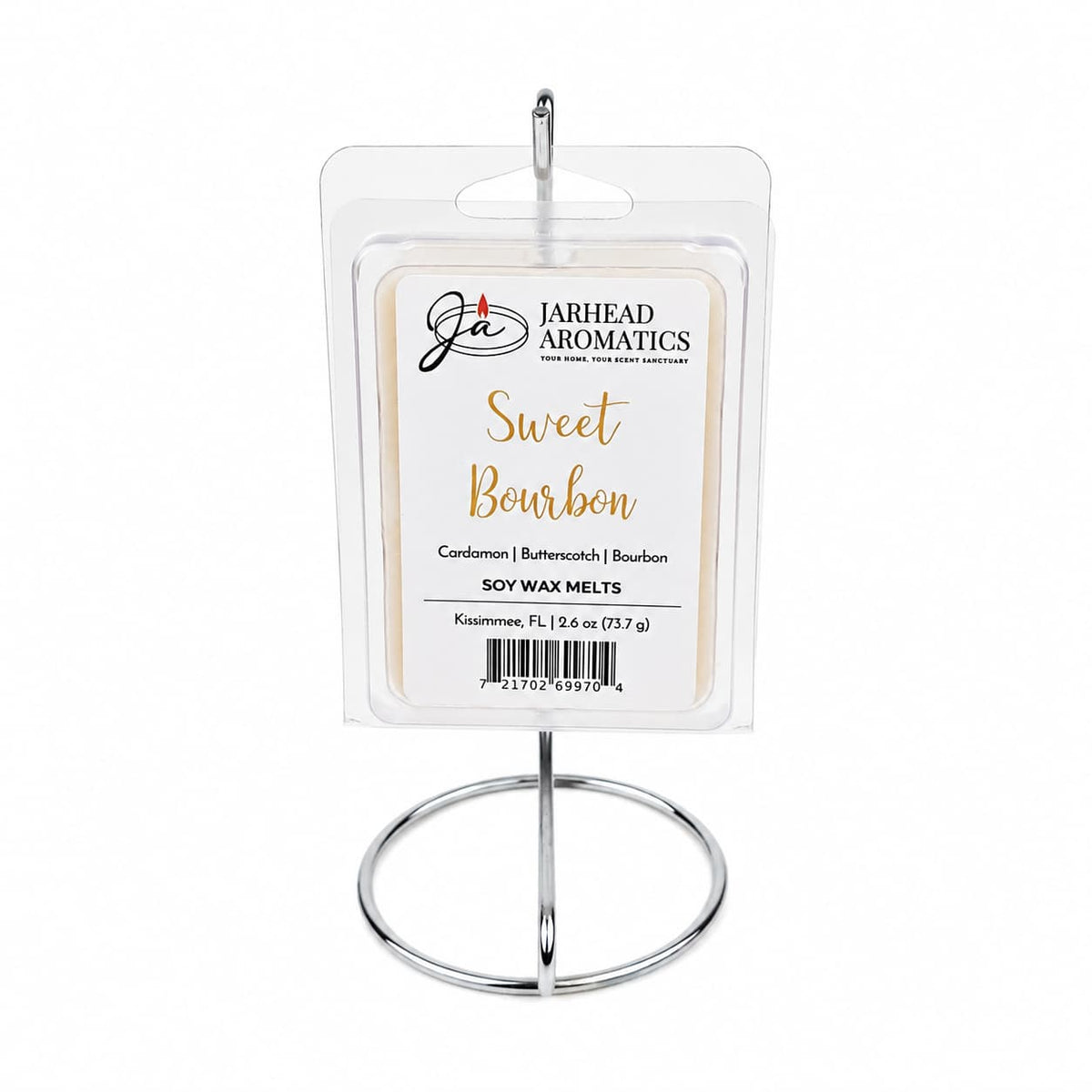 A pack of Jarhead Aromatics Sweet Bourbon Soy Wax Melt is showcased on a silver stand. The clear plastic packaging features a beige and white label that highlights the inviting notes of bourbon, butterscotch, and brown sugar, creating a warm gourmand fragrance for your space and promising long-lasting scent.