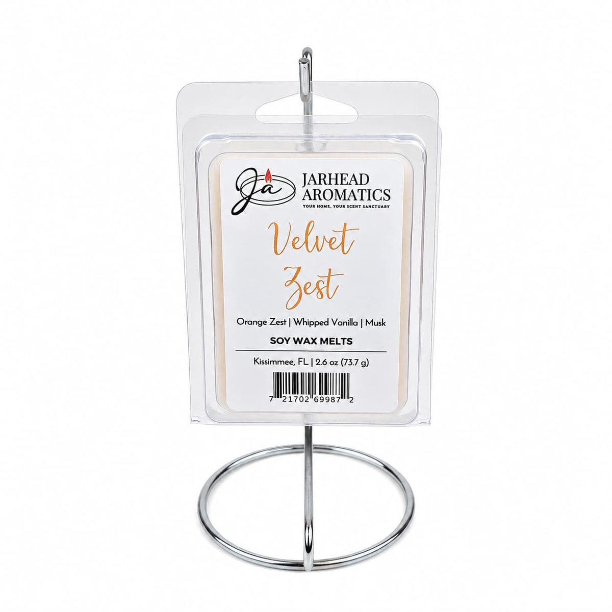 A package of Jarhead Aromatics Velvet Zest Soy Wax Melt | Citrus, Vanilla & Caramel, celebrated for its irresistible gourmand fragrance, is displayed on a silver metal stand against a white background.