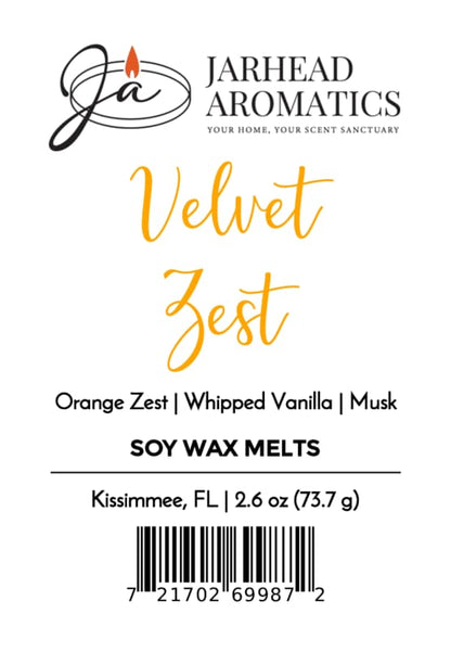 Label for Jarhead Aromatics Velvet Zest Soy Wax Melt | Citrus, Vanilla & Caramel; showcases a gourmand fragrance combining orange zest, whipped vanilla, caramel, and musk. Includes a barcode, net weight 2.6 oz (73.7 g), and location: Kissimmee, FL.