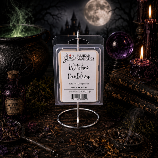 A package of Jarhead Aromatics’ Witches Cauldron Soy Wax Melt | Orange Blossom, Patchouli & Dark Incense is displayed on a stand, surrounded by witchy decor, candles, a Book of Shadows, dried herbs, and a glowing full moon in a spooky, dark setting. This highly fragrant wax melt fills the air with enchanting notes of orange blossom, patchouli, and dark incense—perfectly enhancing the mystical atmosphere.