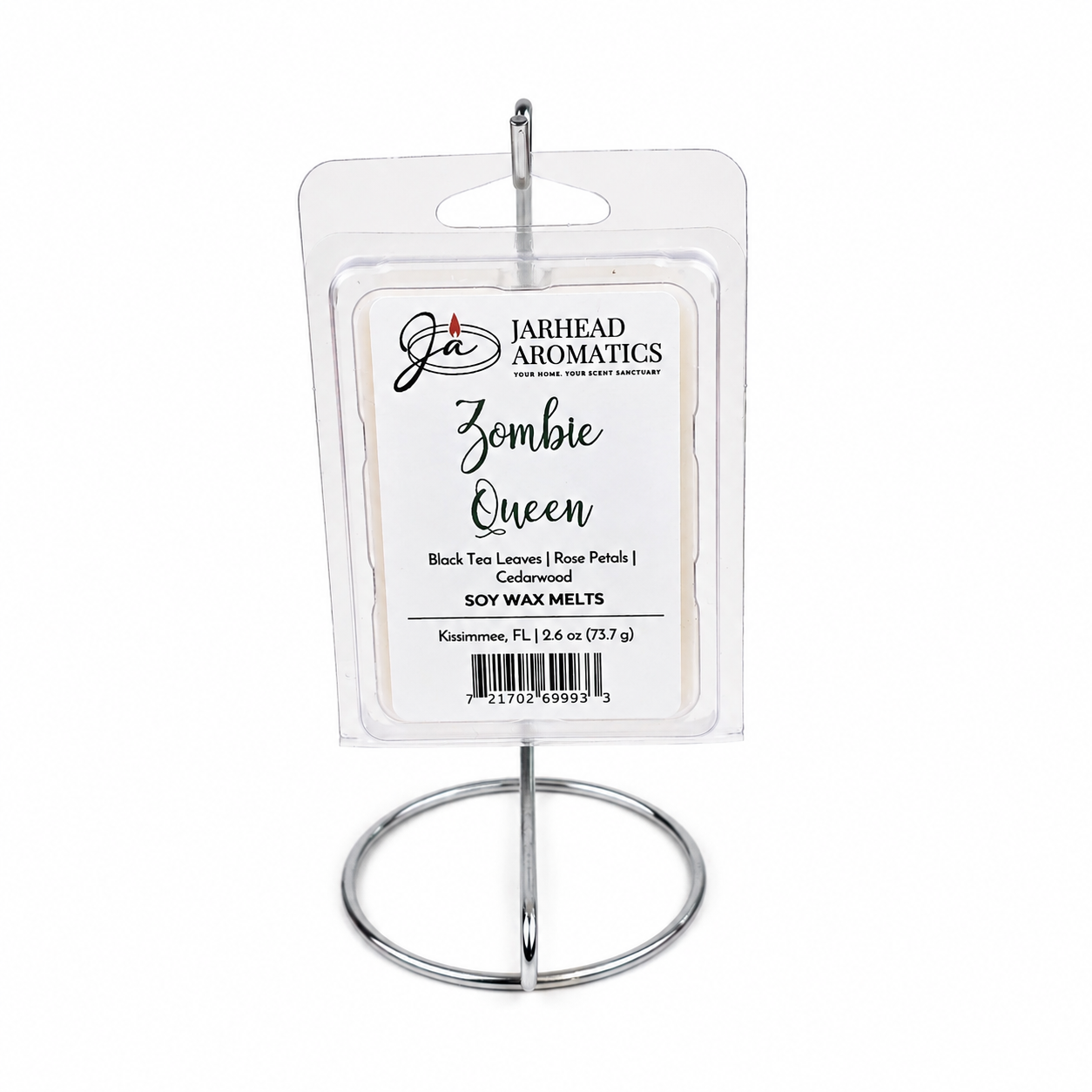 A package of Jarhead Aromatics Zombie Queen Soy Wax Melt | Black Tea, Rose Petals & Cedarwood is displayed upright on a silver metal stand against a white background, highlighting its distinctive blend of floral and smoky black tea fragrance.