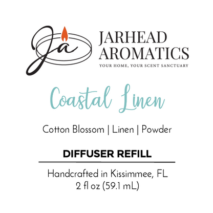 Jarhead Aromatics Coastal Linen - Diffuser Refill label features a stylized JA and flame logo, scent notes of Cotton Blossom, Linen, and Powder, plus details: 2 fl oz, handcrafted in Kissimmee, FL—a true coastal retreat.