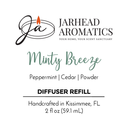 Jarhead Aromatics Minty Breeze Diffuser Refill blends peppermint, eucalyptus, and cedar with a powdery finish. Handcrafted in Kissimmee, FL with essential oils. 2 fl oz (59.1 mL). Logo features a candle flame.