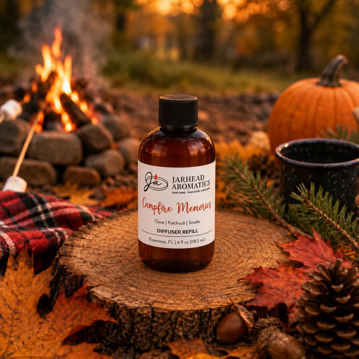 A bottle of Jarhead Aromatics Campfire Memories Diffuser Refill | Maple, Clove & Smoky Embers rests on a tree stump surrounded by autumn leaves, pinecones, a mug, and a glowing campfire in the background. A marshmallow toasts over the flames while a pumpkin adds seasonal charm—all capturing the inviting autumn essence of this cozy home fragrance.