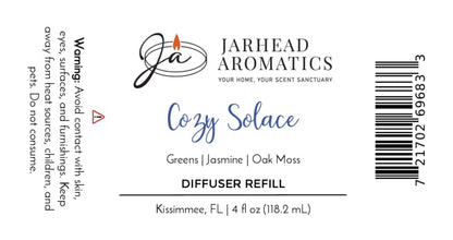 Jarhead Aromatics Cozy Solace Diffuser Refill Fresh Greens • Jasmine • Oak Moss Autumn-inspired home fragrance to elevate your space. Warning (left): Avoid contact with skin, eyes, and surfaces. Keep out of reach of children and pets. Net Contents: 118.2 mL [Barcode on right].