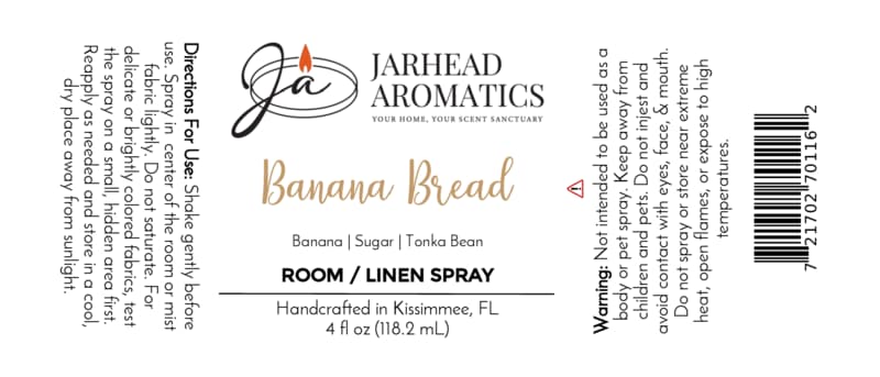 Jarhead Aromatics Banana Bread Room & Linen Spray label, featuring directions, ingredients, warnings, and signature branding with a candle logo. This home and linen fragrance blends the comforting scent of banana, walnut, and warm vanilla—a true gourmand aroma designed to fill your space with the cozy essence of freshly baked banana bread.