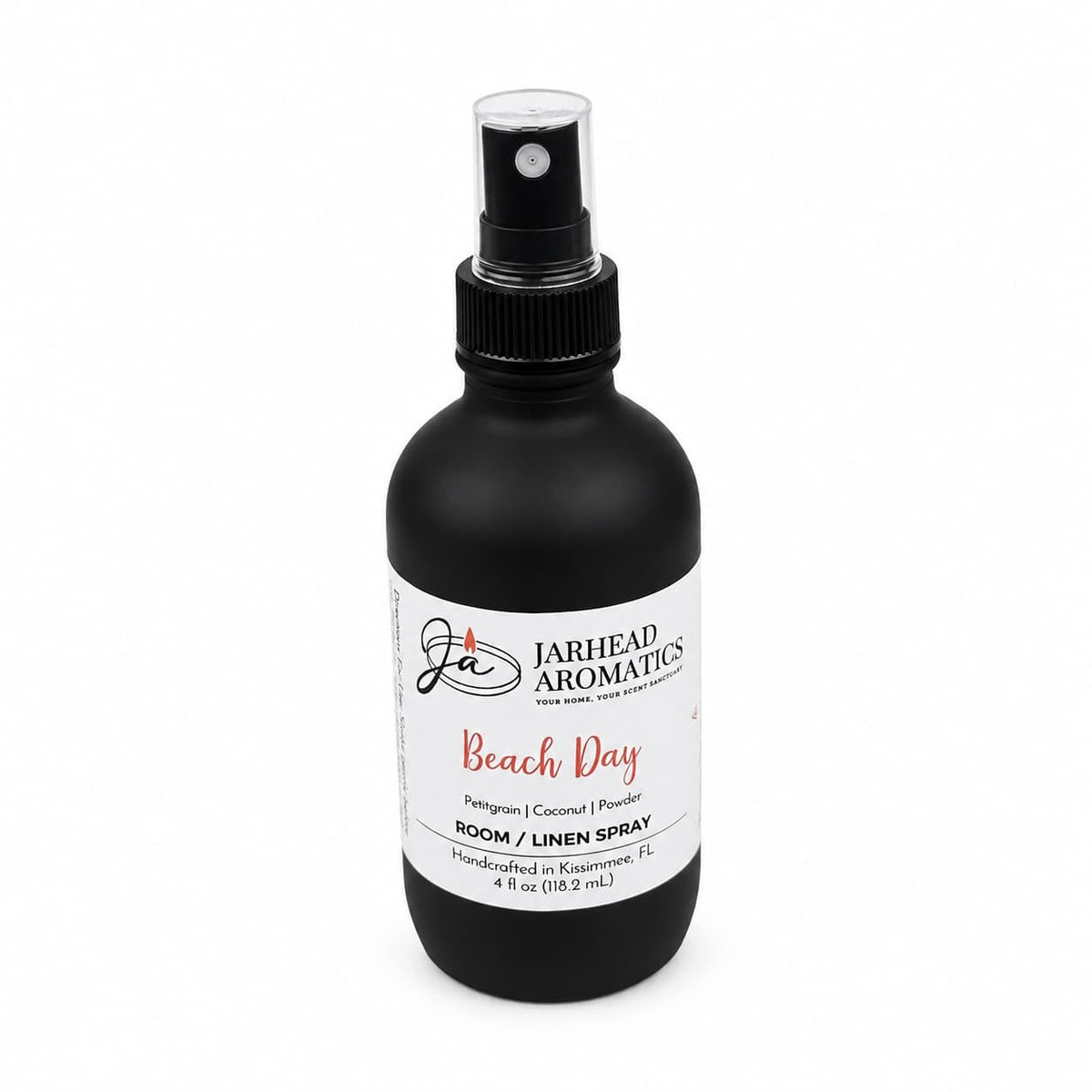 A black spray bottle labeled Jarhead Aromatics Beach Day Room & Linen Spray offers a beach-inspired home fragrance with notes of citrus, coconut, and coastal musk. Handcrafted in Kissimmee, FL, this tropical room and linen spray contains 4 fl oz to freshen any space.