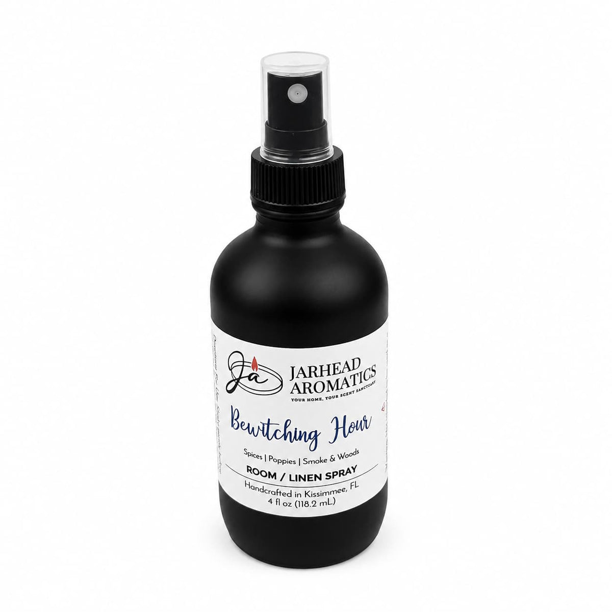 A black spray bottle labeled Jarhead Aromatics Bewitching Hour Room & Linen Spray, featuring exotic spices, dark florals, and smoky woods. Handcrafted in Kissimmee, FL, the bottle displays a white label with blue and black text for a home fragrance blend perfect for enchanting any space.