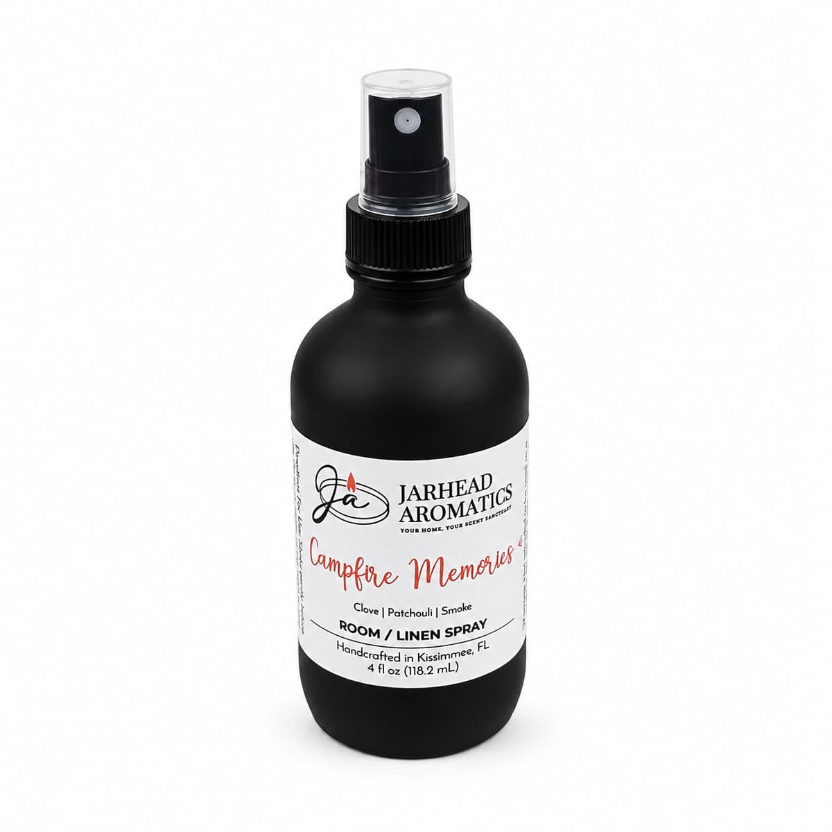 A black bottle of Jarhead Aromatics Campfire Memories Room & Linen Spray, labeled in white and equipped with a spray nozzle, holds 4 oz of fragrance. Infused with scent notes of maple, clove, and smoky embers, this room spray creates the perfect cozy atmosphere for your home.