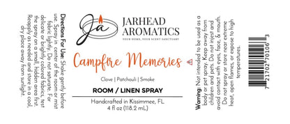 Jarhead Aromatics Campfire Memories Room & Linen Spray label featuring usage directions, scent notes (maple, clove, smoky embers) for a smoky home fragrance experience, warning, and product details; white background with orange and black text, and a candle logo.