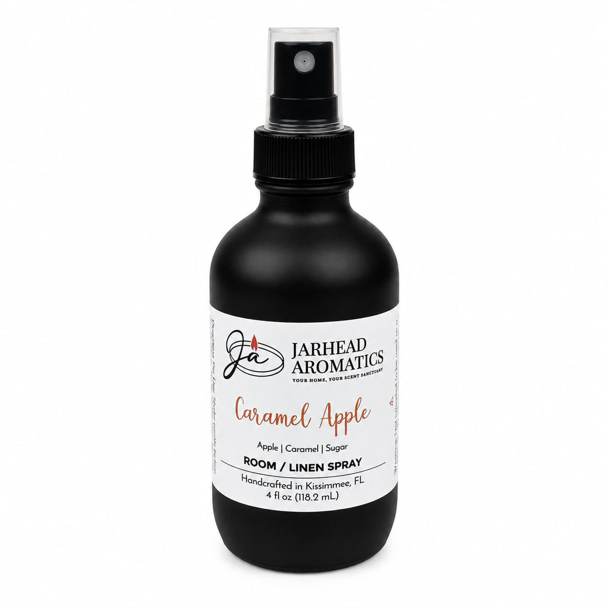 A black spray bottle labeled Jarhead Aromatics Caramel Apple Room & Linen Spray features the crisp scents of apple, caramel, and warm spice. This fall-inspired home fragrance boasts a white label and black cap for an elegant touch.