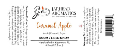Jarhead Aromatics Caramel Apple Room & Linen Spray | Crisp Apple, Caramel & Warm Spice features a label with directions, ingredients, warnings, the Jarhead Aromatics logo, and a barcode. Handcrafted in Kissimmee, FL, this spray fills your home with a sweet fall fragrance and is available in a 4 fl oz (118.2 mL) bottle.