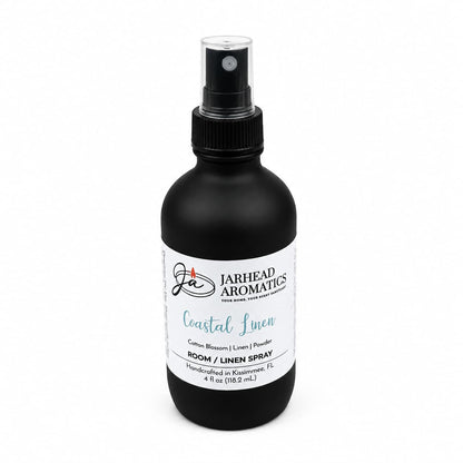 A black spray bottle labeled Jarhead Aromatics Coastal Linen Room & Linen Spray brings a premium home fragrance to any space, featuring fresh linen, ozone, and sandalwood notes. This 4 fl oz (118.2 ml) spray is perfect for refreshing rooms or linens.