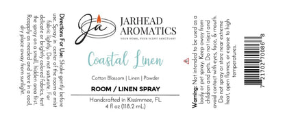 Label for Jarhead Aromatics Coastal Linen Room & Linen Spray, 4 fl oz. Infuse your space with the invigorating scent of fresh linen, ozone, and sandalwood using our Coastal Linen Room & Linen Spray—expertly crafted to refresh and elevate your home environment. Includes usage directions, safety warnings, and ingredients (fresh linen, cotton blossom, ozone, powdery notes). Features the signature Jarhead Aromatics logo with a candle and notes its manufacturer location: Kissimmee, FL.