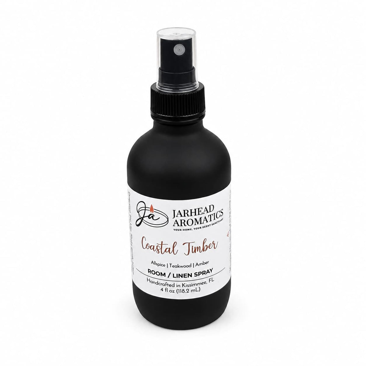 A black spray bottle of Jarhead Aromatics Coastal Timber Room & Linen Spray | Teakwood, Leather & Warm Amber, 4 fl oz, is displayed against a white background—this luxury home fragrance combines sophisticated woodsy notes of teakwood, leather, and warm amber to elevate any space.
