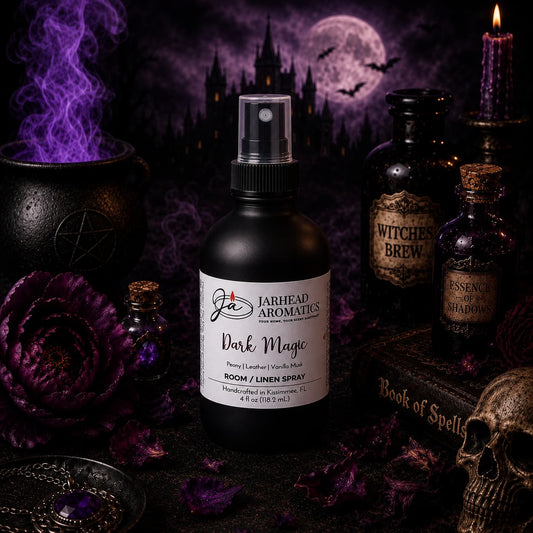 A bottle of Dark Magic Room & Linen Spray | Peach, Plum, Leather & Vanilla Musk by Jarhead Aromatics rests amid gothic decor—featuring a cauldron, potion bottles, purple flowers, and a spell book—with a haunted castle and glowing full moon in the distance. Wisps of purple smoke wind through the scene, evoking an enchanting atmosphere ideal for those seeking an alluring home fragrance.