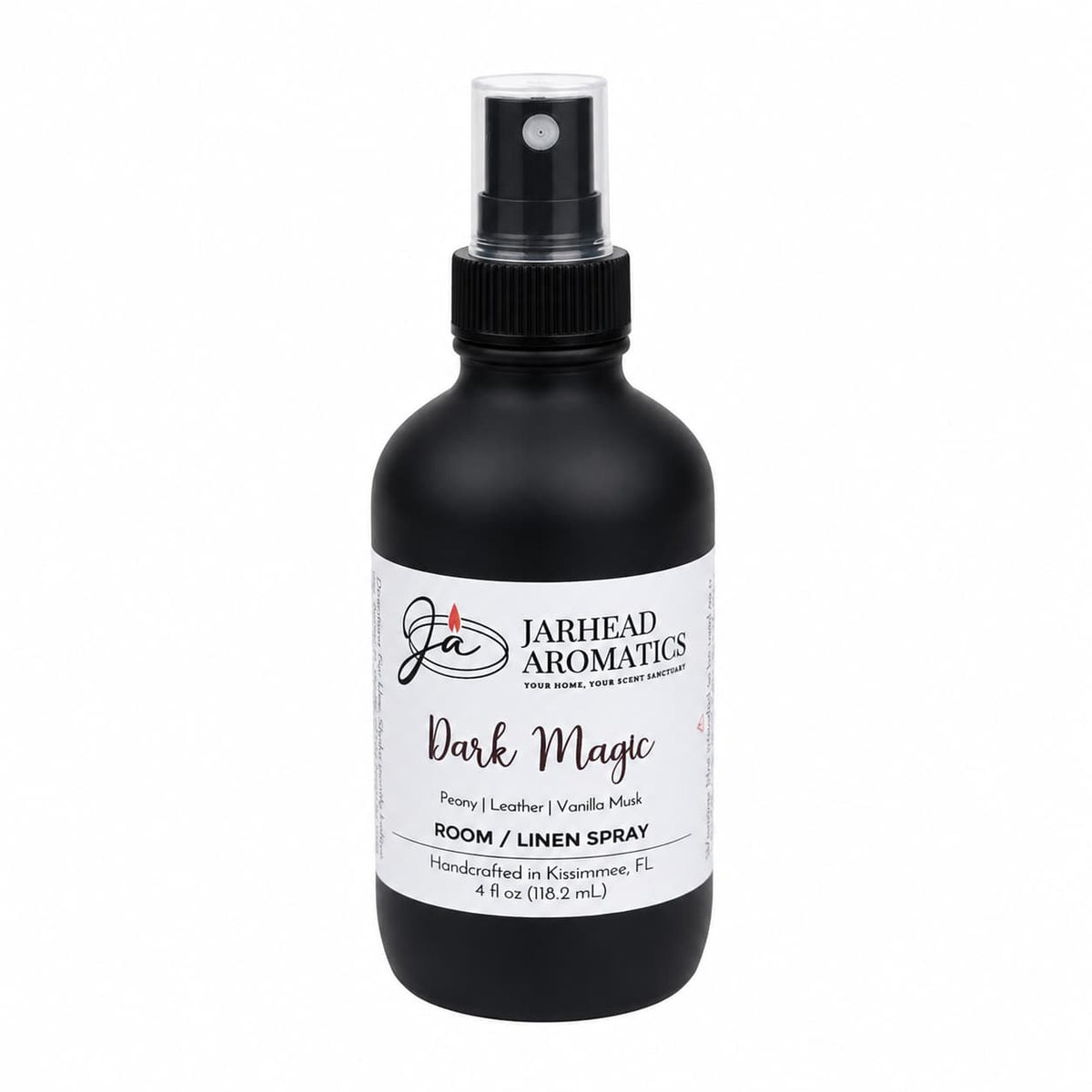 A black spray bottle labeled Jarhead Aromatics Dark Magic Room & Linen Spray with peach, plum, dark floral, and vanilla musk scents, 4 fl oz, handcrafted in Kissimmee, FL—an inviting home fragrance from Jarhead Aromatics.
