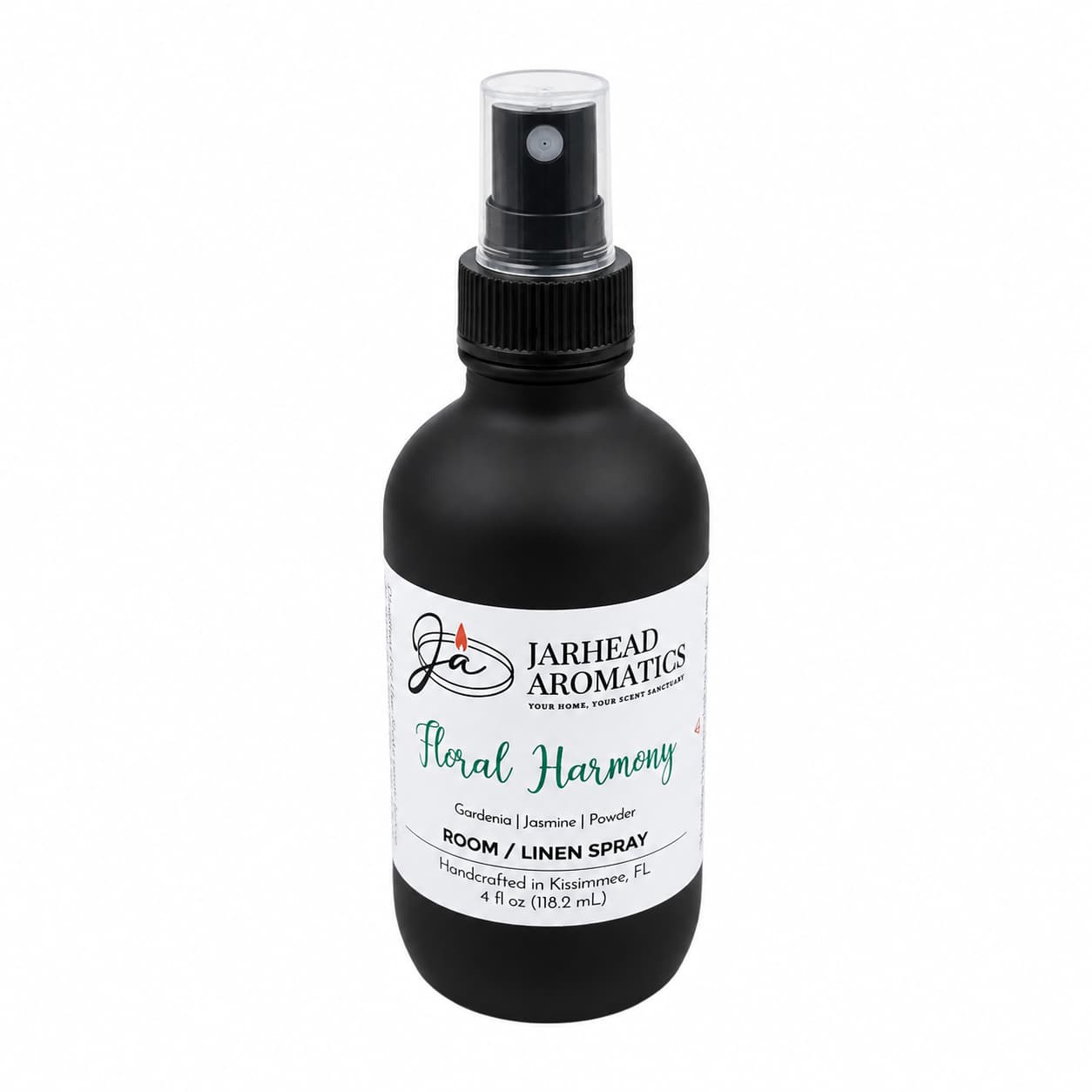 A black 4 oz spray bottle labeled Jarhead Aromatics contains the Floral Harmony Room & Linen Spray, a home fragrance that blends gardenia, jasmine, and tuberose for a refreshing floral scent.