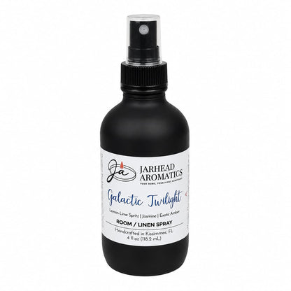 A sleek black spray bottle labeled Jarhead Aromatics Galactic Twilight Room & Linen Spray, featuring a refined home fragrance with notes of bergamot, amber, and sandalwood. Handcrafted in Kissimmee, FL, this elegant 4 fl oz (118.2 mL) bottle is perfect for elevating the ambiance of any room or linen.